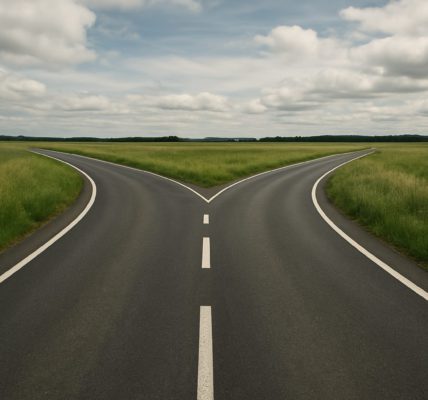A fork in the road surrounded by green fields and cloudy skies